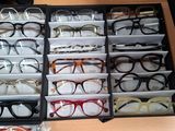 many pairs of glasses in a case on the table
