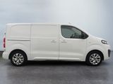 the white van is parked in a parking lot on a cloudy day