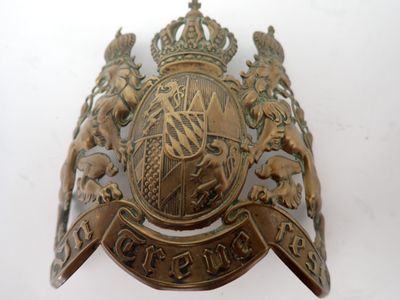 a metal badge on a white surface with a white background