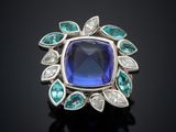 an image of a blue sapphire and diamond ring on a black surface