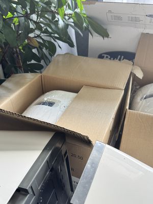 de nombreux cartons d'objets posés à même le sol
