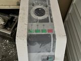 a microwave sitting on top of a counter next to a trash can