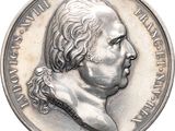 an image of a silver coin with a portrait of a man on it