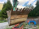 a large piece of wood that is being lifted by a crane