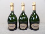 three bottles of wine sitting on a table next to each other