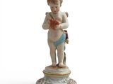 figurine représentant un Cupidon tenant une pelote de laine et des aiguilles à tricoter