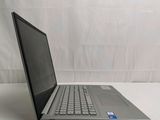 the laptop is sitting on a white surface with a white curtain in the background