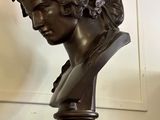 a bust of a woman on a pedestal in a room