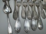 a lot of silver spoons and forks on the table
