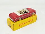 a red toy car sitting on top of a yellow box