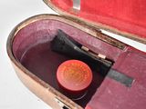 a red case with a red lid and a black handle