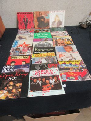 a table that has a bunch of different album covers on it