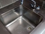 a stainless steel sink with a faucet and a faucet