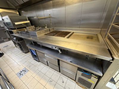 a large commercial kitchen with stainless steel counter tops