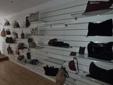 a room with a lot of shoes and bags on the shelves