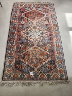 a large rug with a multicolored design on a white floor