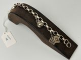 a close up of a metal bracelet with a tag on it