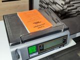 a scale with a book on it sitting on a counter