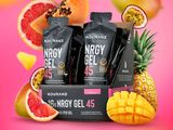 two packets of energy gels with fruit on a pink background