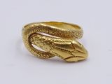 an image of a gold snake ring on a white surface