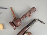 a pipe and a pipe holder on a table