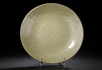 an image of a green plate on a stand against a black background
