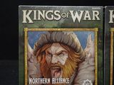 two boxes of king of war northern alliance cards on a black surface