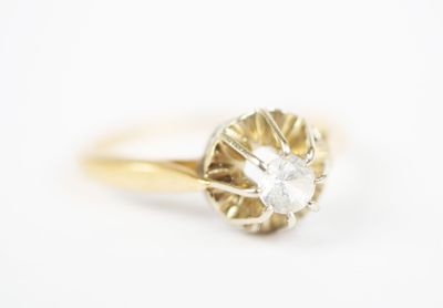 a close up of a diamond ring on a white surface