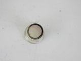 a small black and white object in the middle of a white surface
