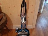 a vacuum that is sitting on a hard wood floor