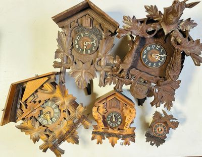 a lot of cuckoo clocks that are on the wall
