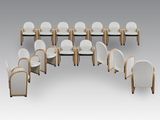 a group of white chairs with wooden legs and white cushions