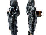 pair of black and gold figurines of a woman holding a book