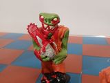 toy figurines of a man with a chainsaw on a checkered table