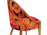 an orange and black chair with a wooden legs and a patterned seat