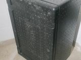 a black box sitting on the floor next to a toilet