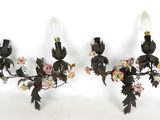 pair of black and white wall sconces with flowers and leaves