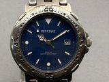 a close up of a watch with a blue face