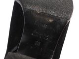 the bottom of a pair of black leather shoes with a black sole