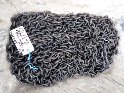 a close up of a pile of metal chain with a tag on it