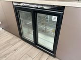 a refrigerator with two glass doors in a kitchen