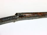 a close up of a piece of metal with a piece of rust on it