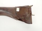 an old brown leather holster with a tag on it