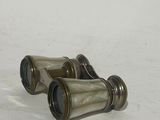 pair of antique brass binoculars on a white background