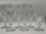 six clear wine glasses and a wine glass on a table