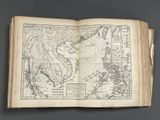 an old book with a map of the world on it