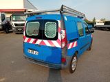 a blue van that is parked in a parking lot