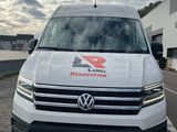 a white van parked on the side of a road next to a building