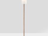 a copper floor lamp with a marble base and a white shade