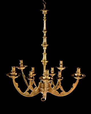 a brass chandelier with five arms and five candles